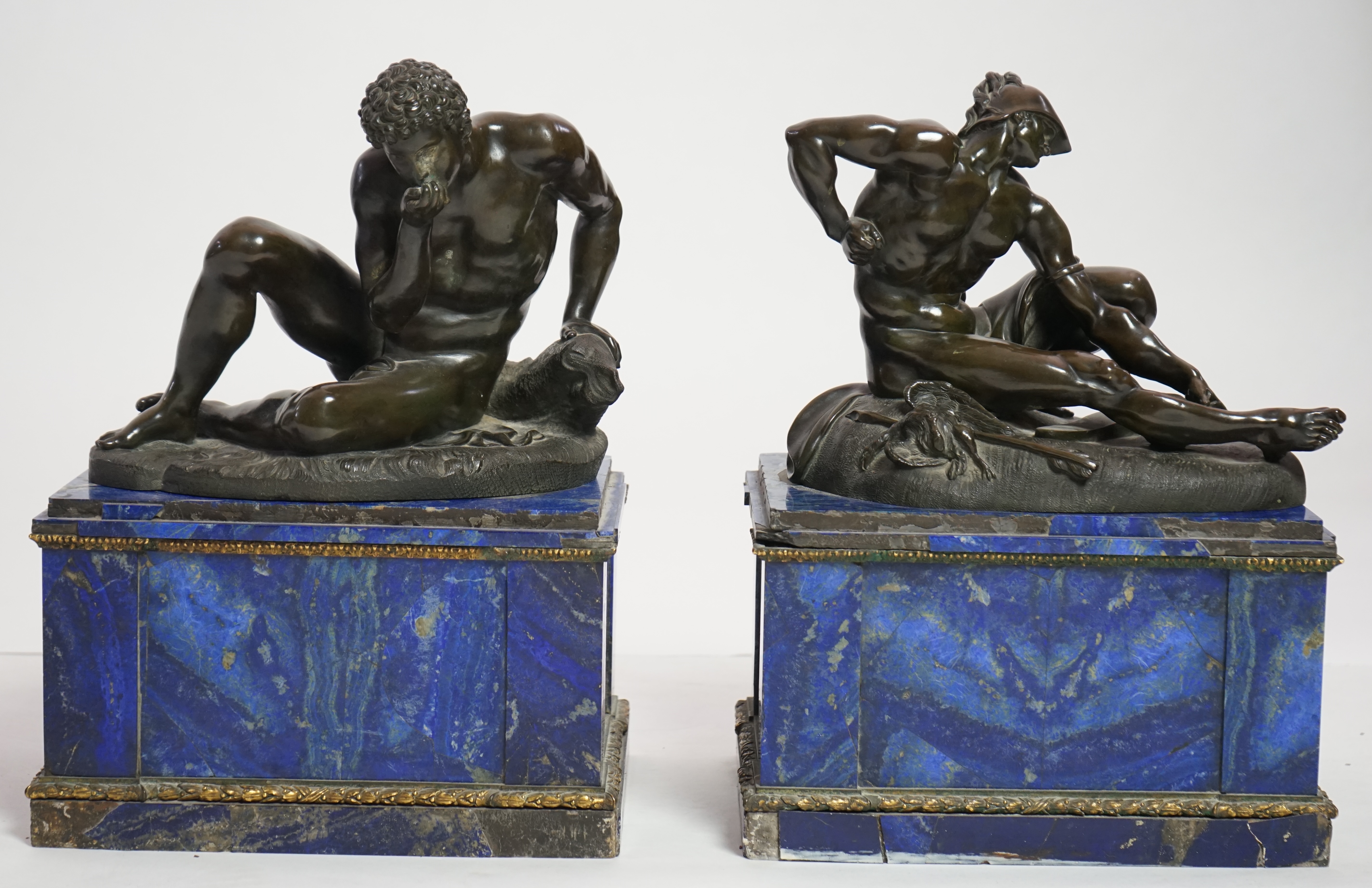 After the antique, a pair of late 18th/early 19th century Grand Tour souvenir bronze figures of seated warriors